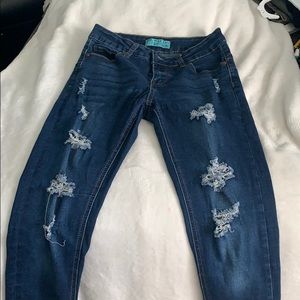 Blue jeans with holes and cuffed ankles